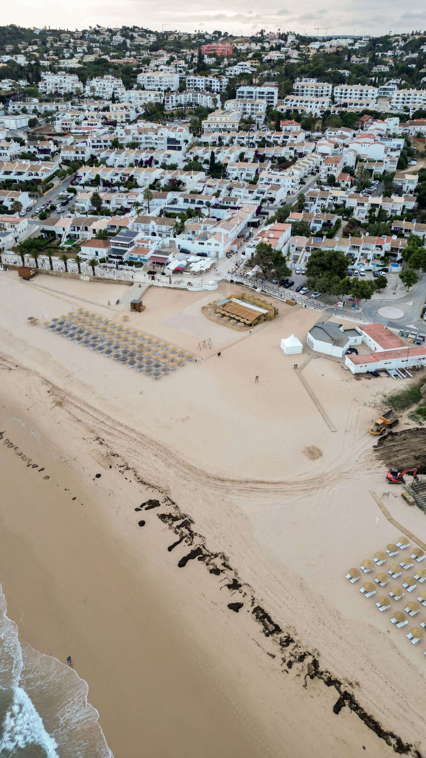 Aerial view of Praia da Luz with golden sand beach, clear waters, and coastal village in Algarve, Portugal